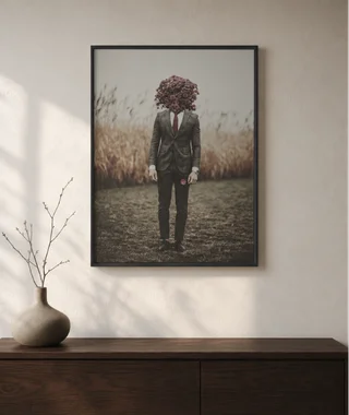 Framed surreal figure with a flower head displayed above a console